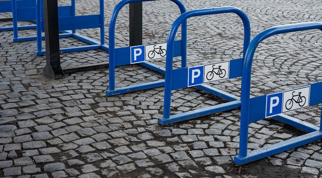 Carousel_blue-bike-parking-sign-with-a-bicycle-background-2023-11-27-04-49-15-utc__1_