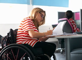 Normal_teenage-girl-in-wheelchair-writing-up-notes-in-cla-2022-03-07-23-57-28-utc__1_