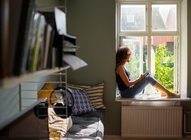 Normal_normal_woman-sitting-on-window-sill-and-using-smart-phone-2022-02-02-03-56-54-utc__1_