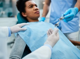 Normal_close-up-of-dental-assistant-passing-syringe-to-a-2023-11-27-05-05-00-utc__1_