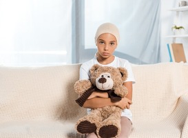 Normal_sick-child-sitting-on-sofa-and-holding-teddy-bear-2023-11-27-05-30-39-utc__1_